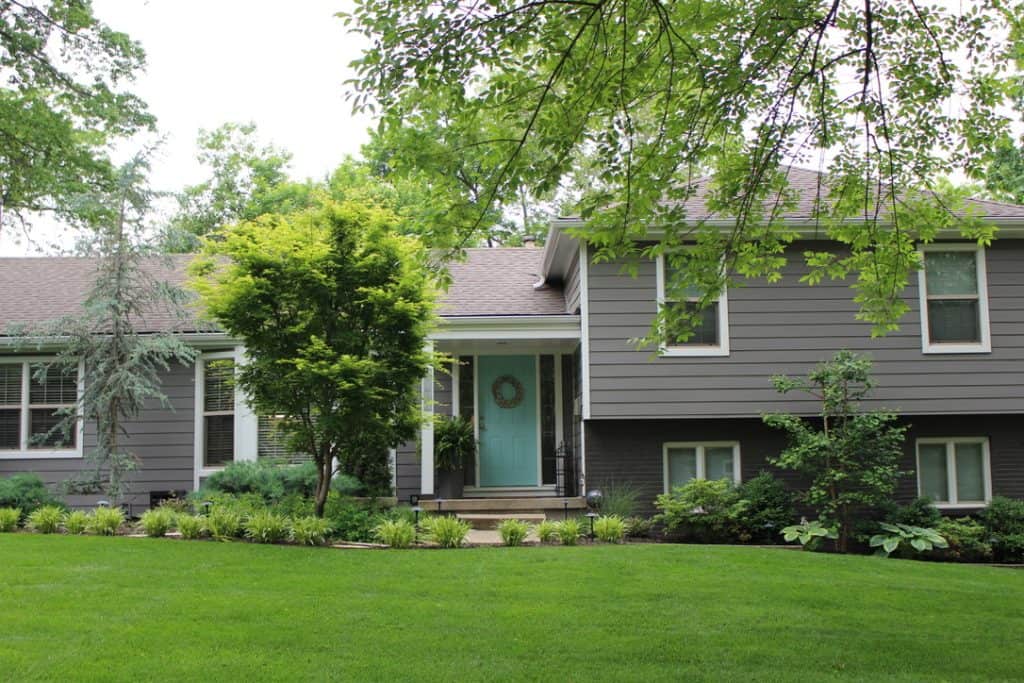 Beautiful Kansas City home with lush landscaping and modern exterior design.