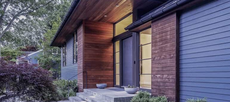 Kansas City exterior home with wood accents and lush landscaping.